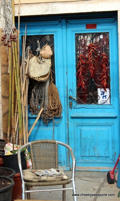 A bright blue door with fishing tackle and bamboo rods - Treasures of Istria