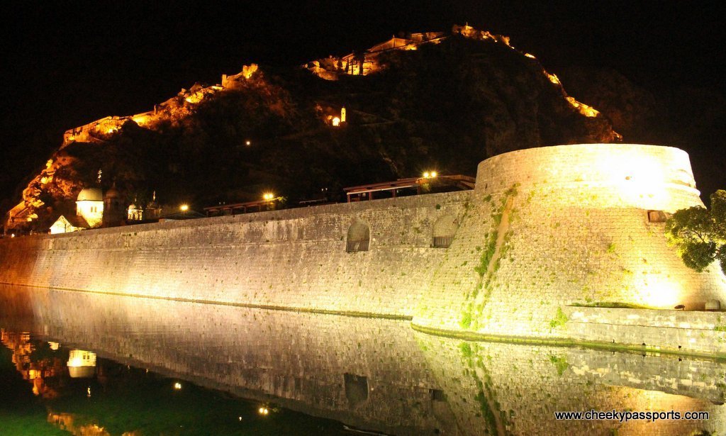 The old town walls of Kotor are lit up by night - a top reason to visit Montenegro