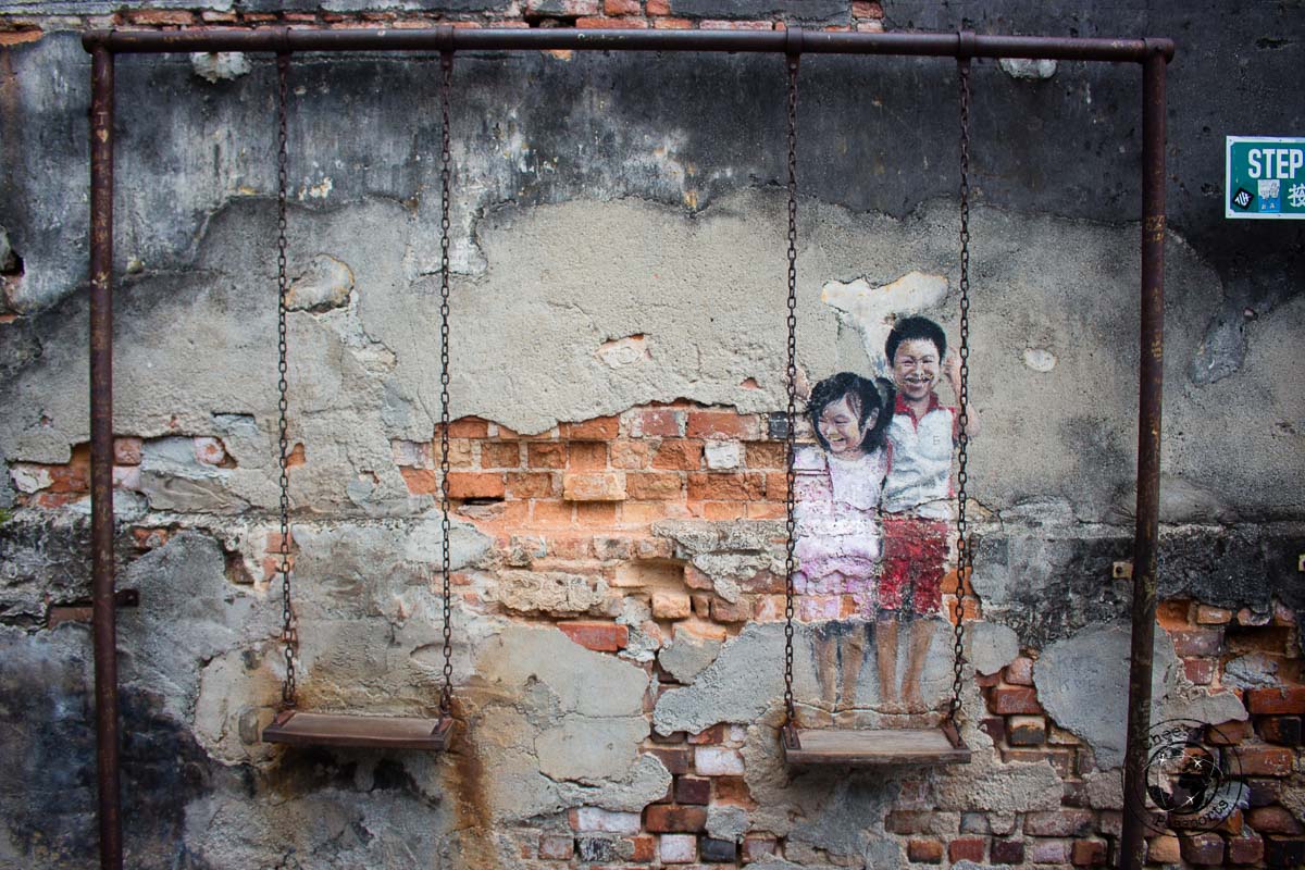Brother and Sister on a swing - street art in penang