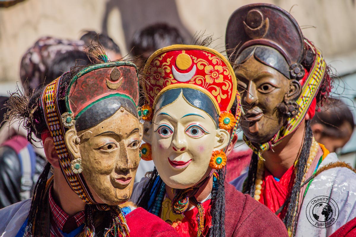 Masked participants at the Tawang festival parade - North East India Travel Guide