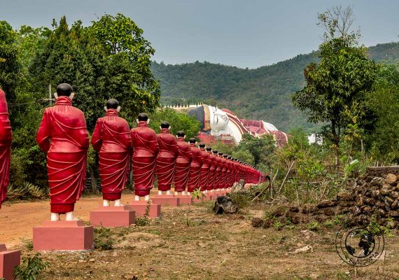 monk statues leading to the reclining buddha - things to do in Mawlamyine